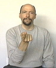 end of 'I tell you'. the dominant hand with index finger extended, palm up, is pointing to a point in front of the signer.